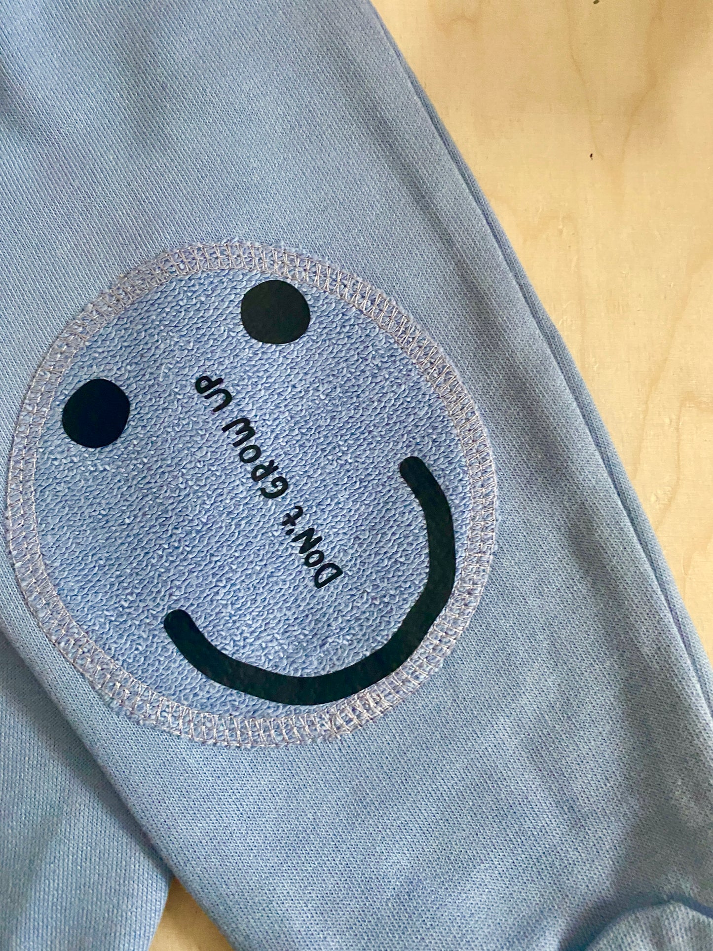 DON'T FORGET TO SMILE ON BLUE PATCHES PANTS